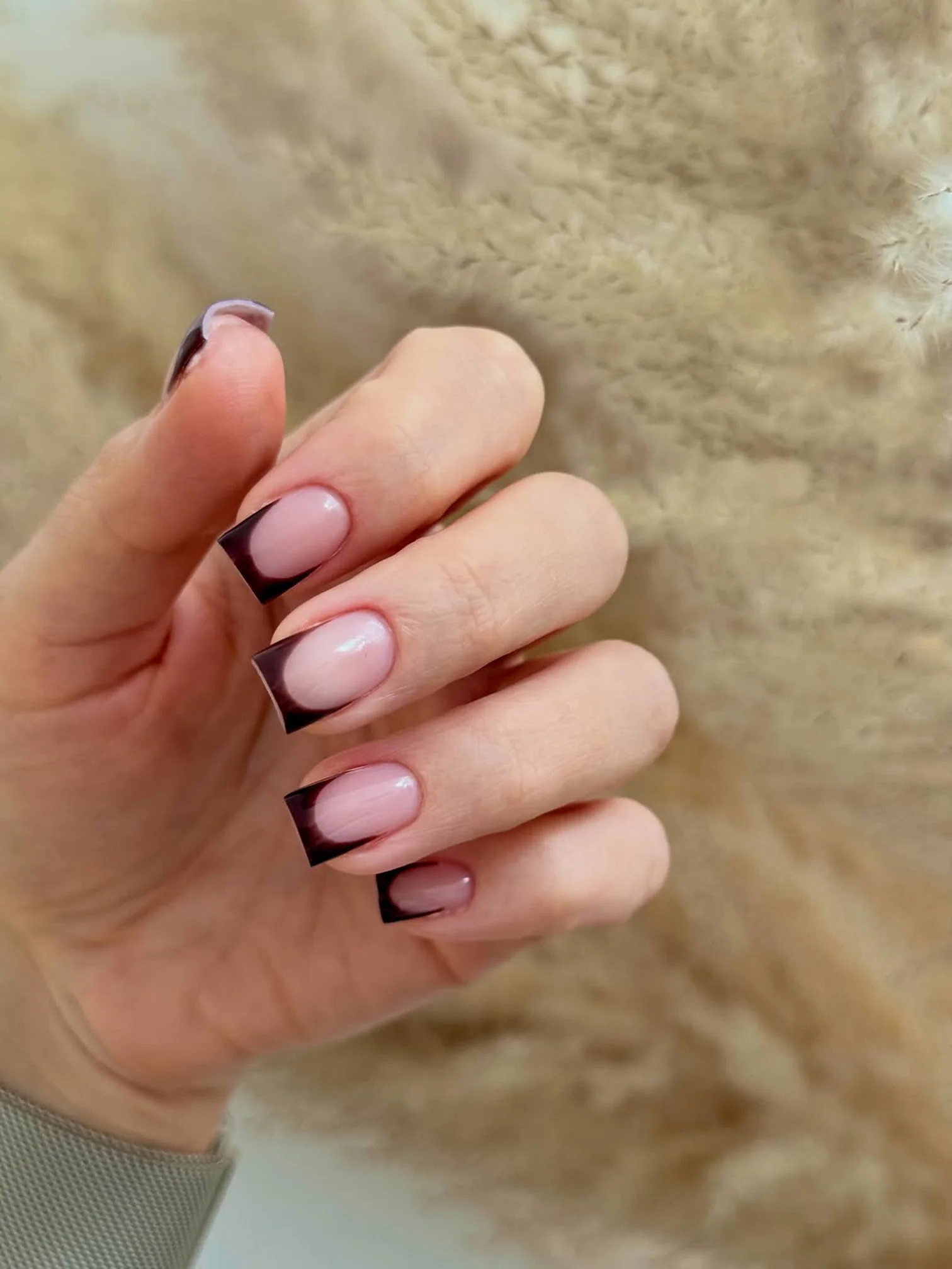 Nude nails with a black French tip