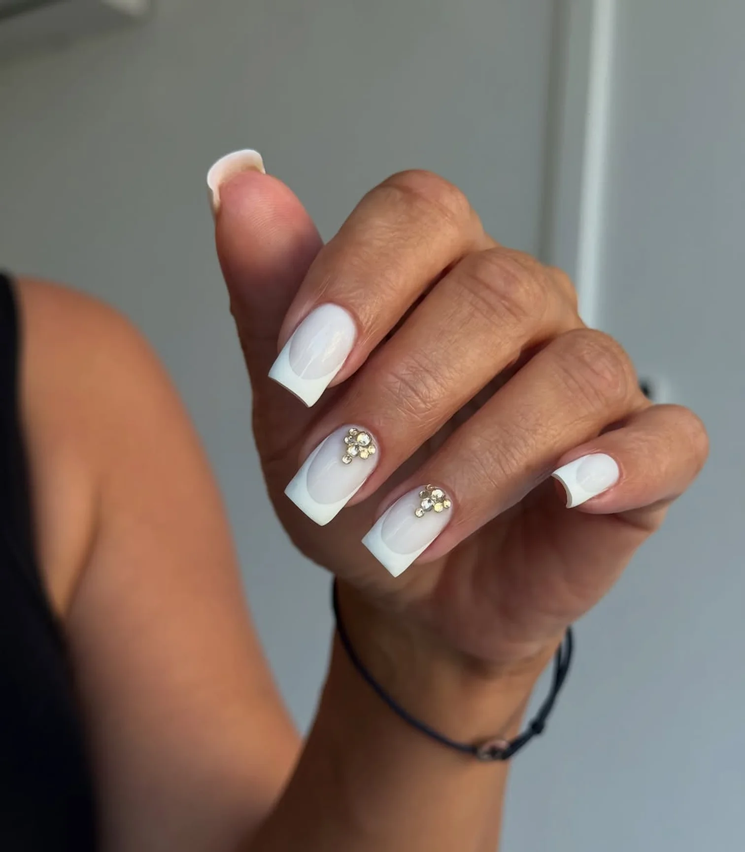 Milky white nails with small crystal details